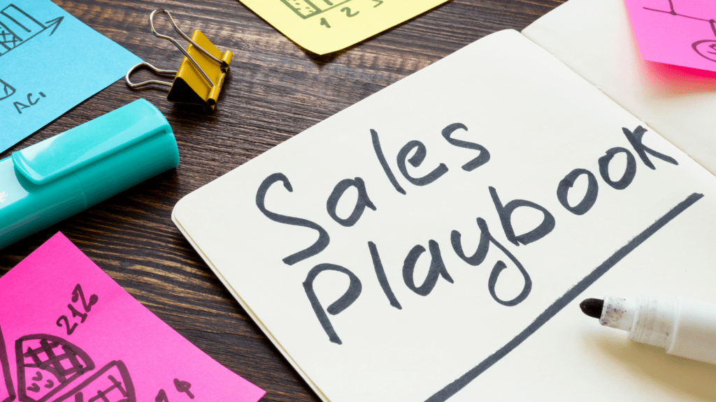 Sales playbook concept with notebook and planning materials, representing strategies for distributed leadership, sales teamwork, and business scalability.